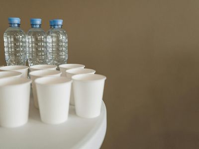 Minimalist water bottle on a white bench.